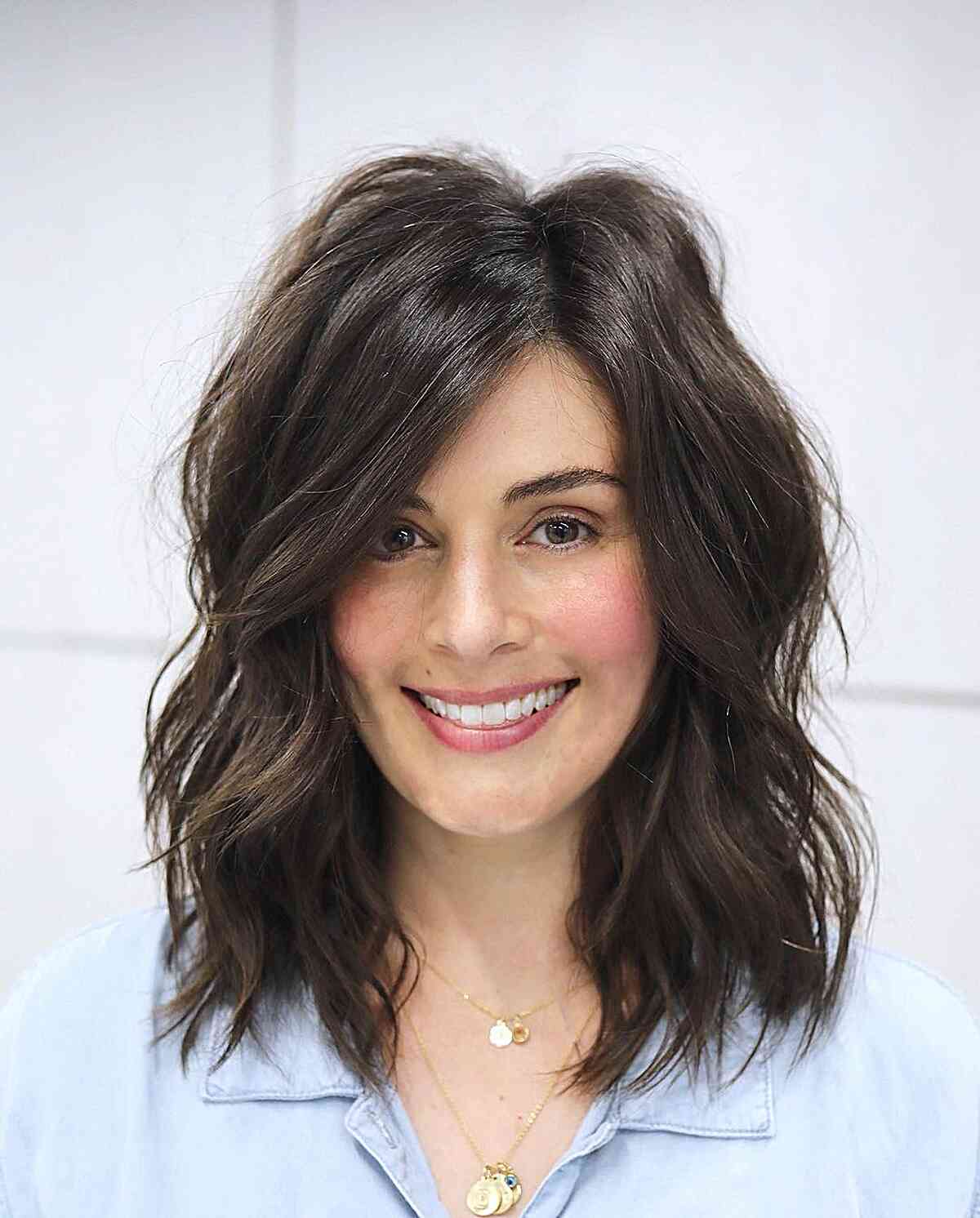 Contemporary Collarbone-Length Side Parted Tousled Hairstyle