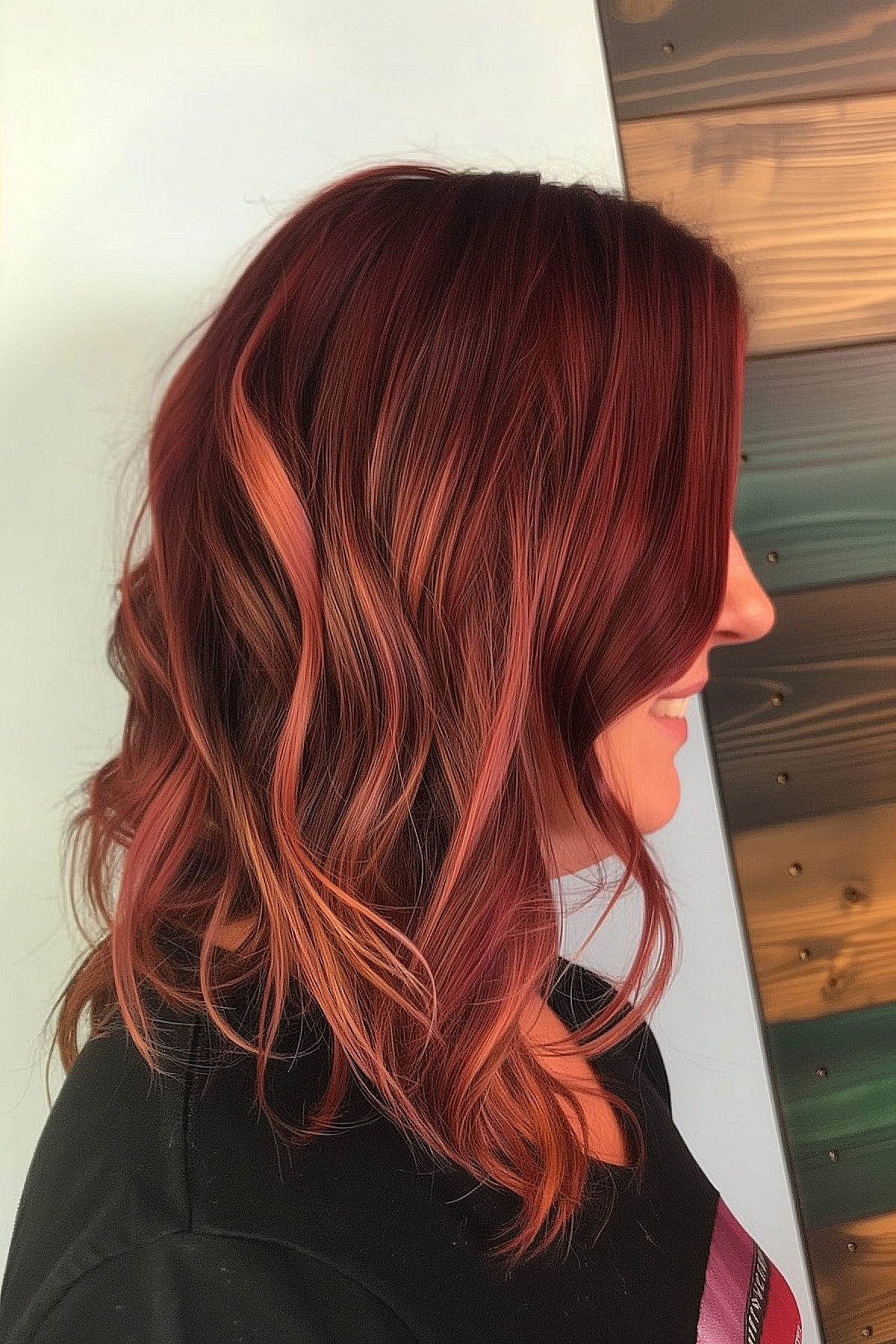 Medium asymmetrical lob featuring a reverse ombre transitioning from crimson to copper