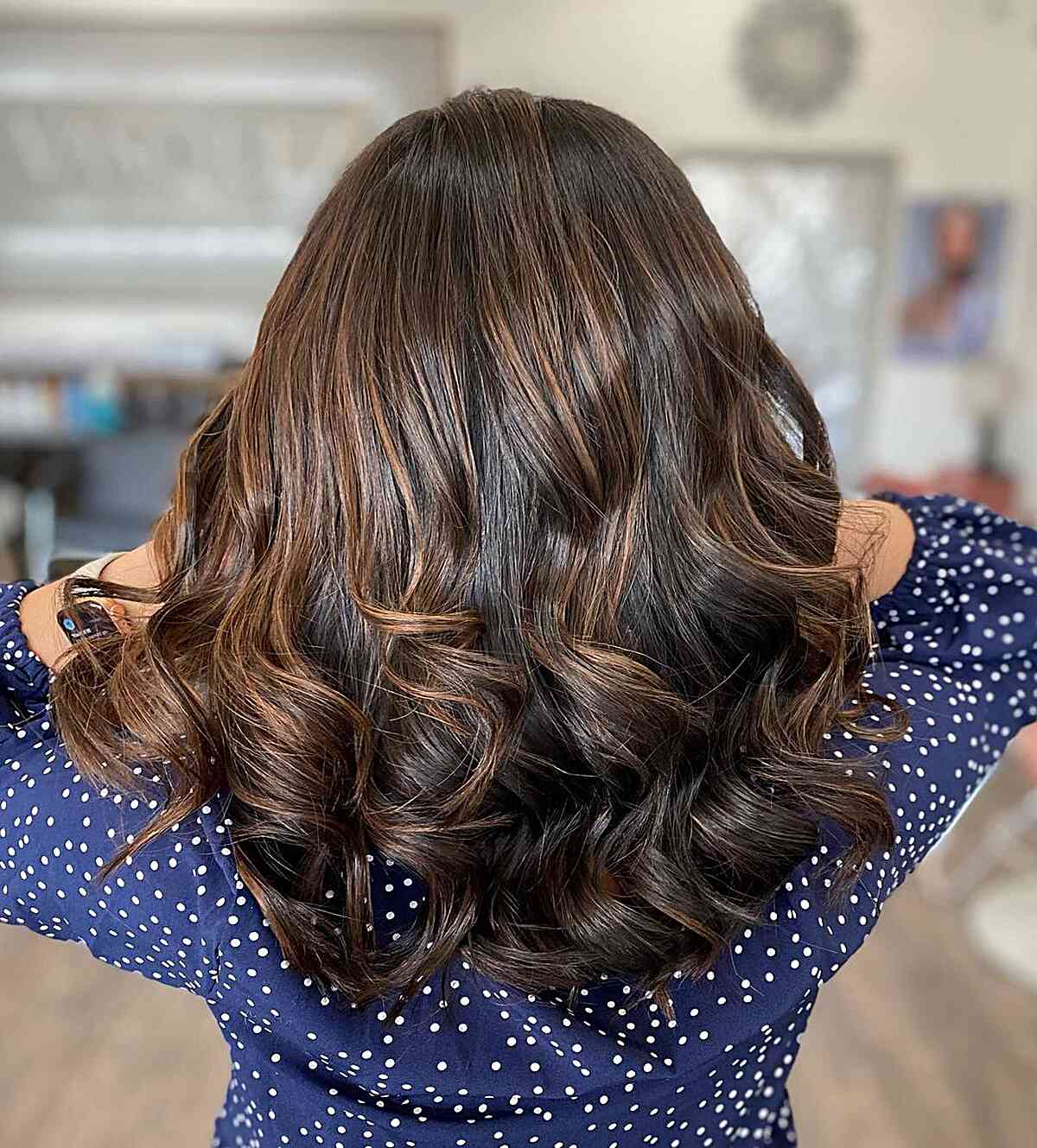 Highlights of Chocolate Caramel Brown Balayage with Curly Ends on Mid-Length Dark Brunette Hair