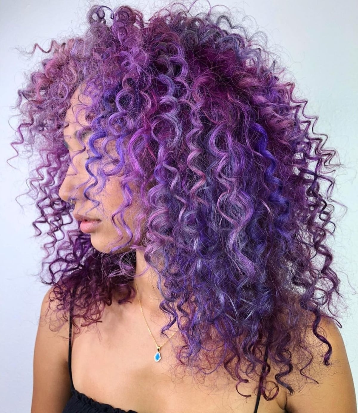 Curly hair styled in magenta-lavender