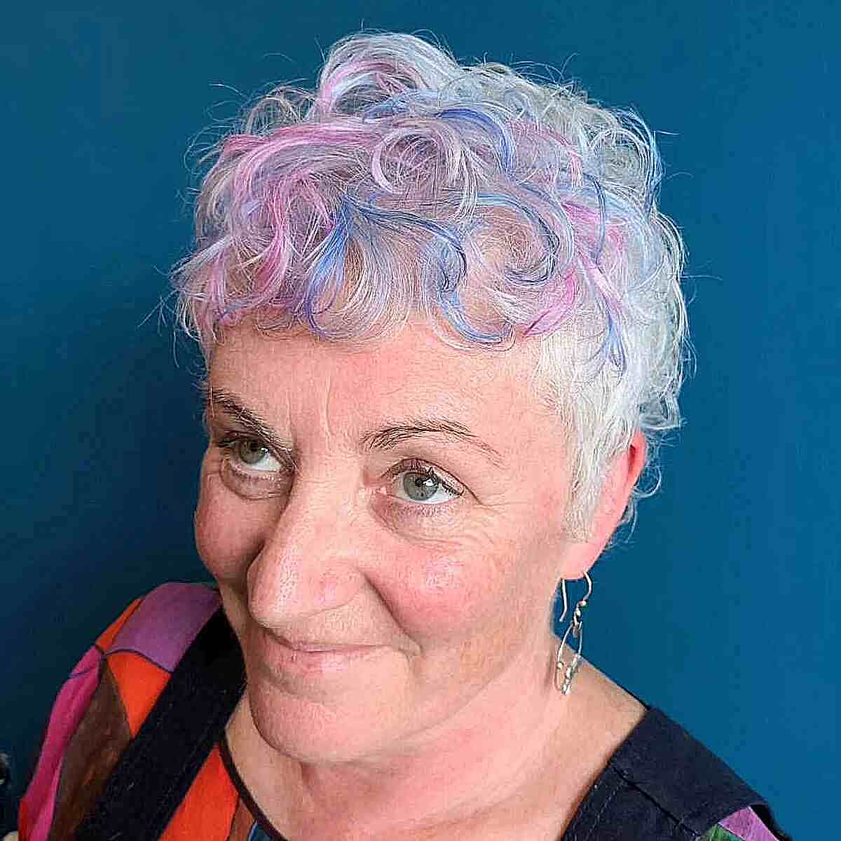 Wash-and-Wear Curly Pixie with Pink and Blue Highlights for Women Over 50
