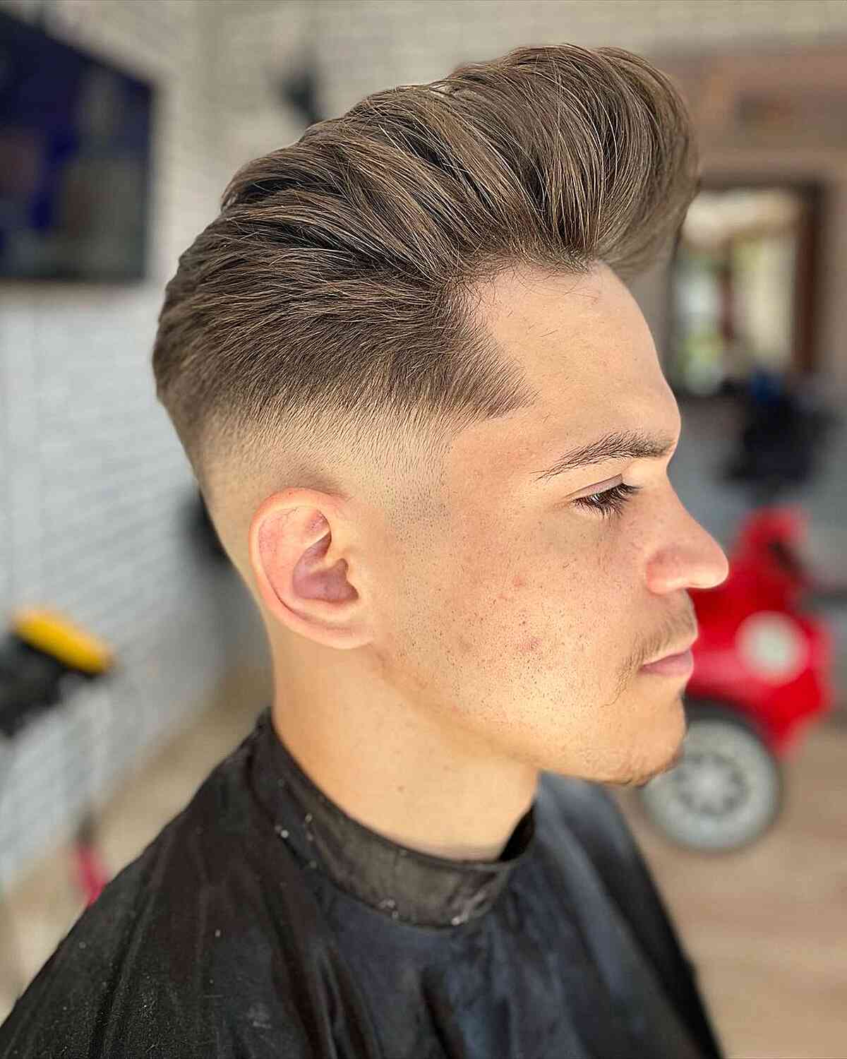 Defined Bald Fade on Pompadour Hair for Men's Long Face Shape