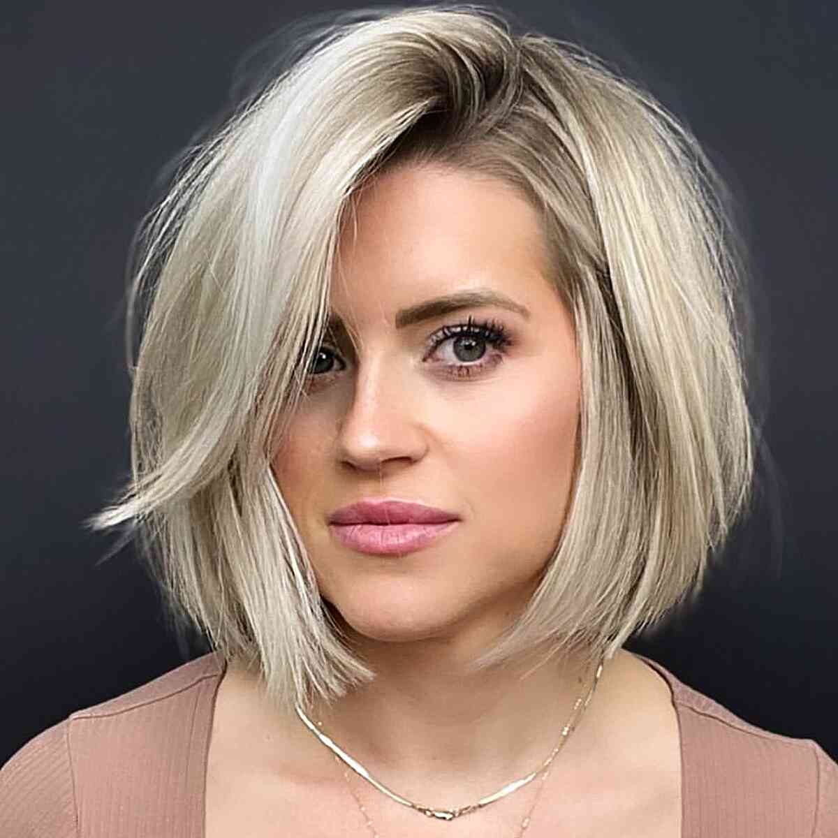 Stylish Blunt and Side Parted Dual-Part Reversible Bob Cut for women with soft blonde hair