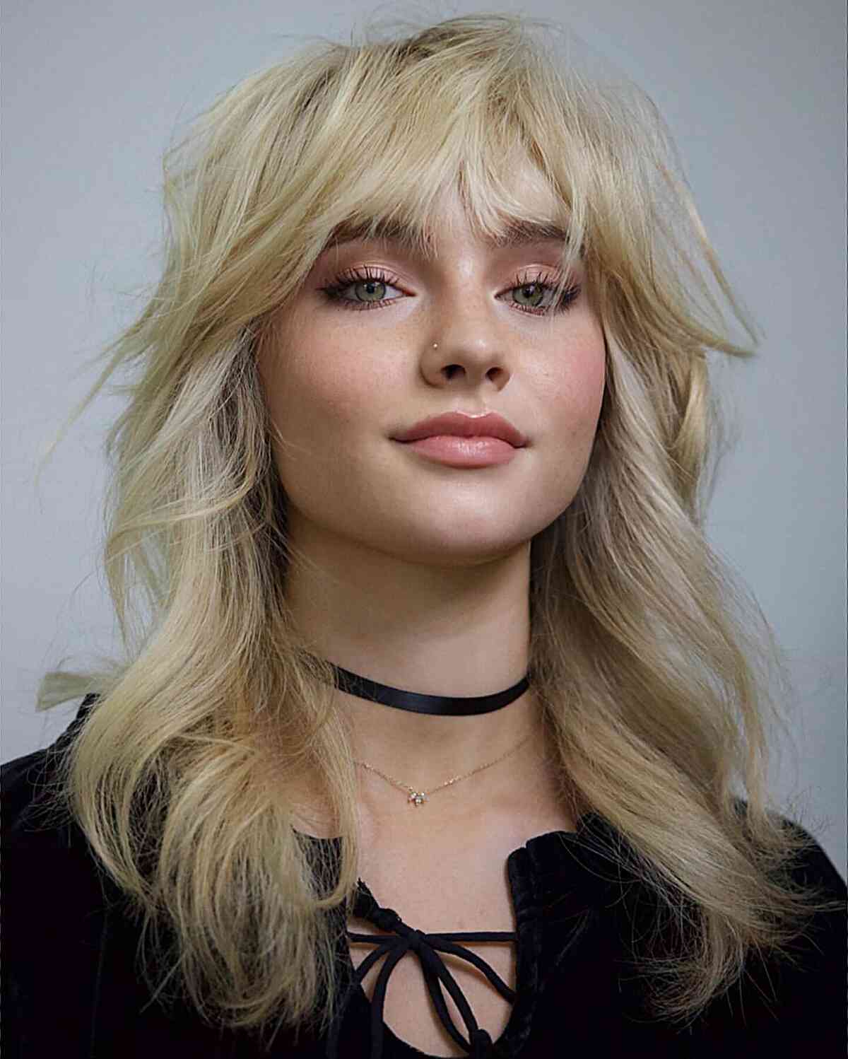Mid-Length Effortlessly Tousled Blonde Shag with Face-Framing Bottleneck Bangs