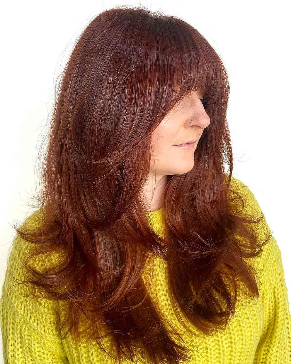 Long Elegant Blowout on a Layered Haircut with Bangs for a 40-year-old lady