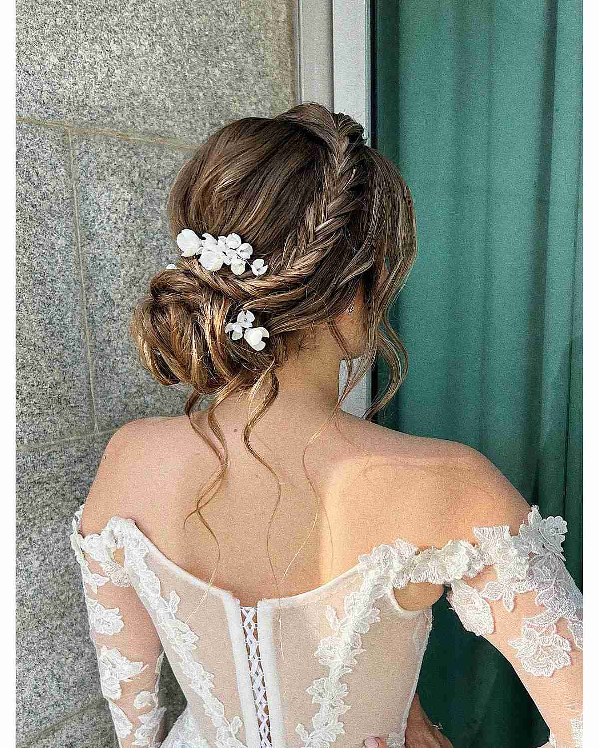 Elegant Braided Updo with Floral Accent for Weddings