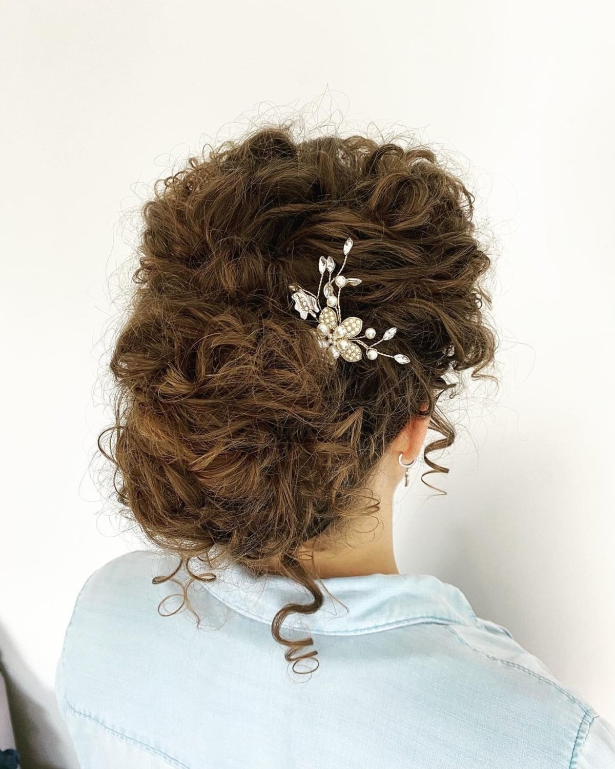 Curly updo with headpiece styled for bridesmaids