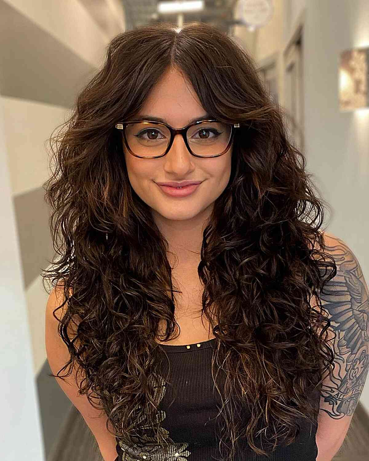 Elegant Long Curled Hair with Flowing Curtain Bangs for Women with Glasses