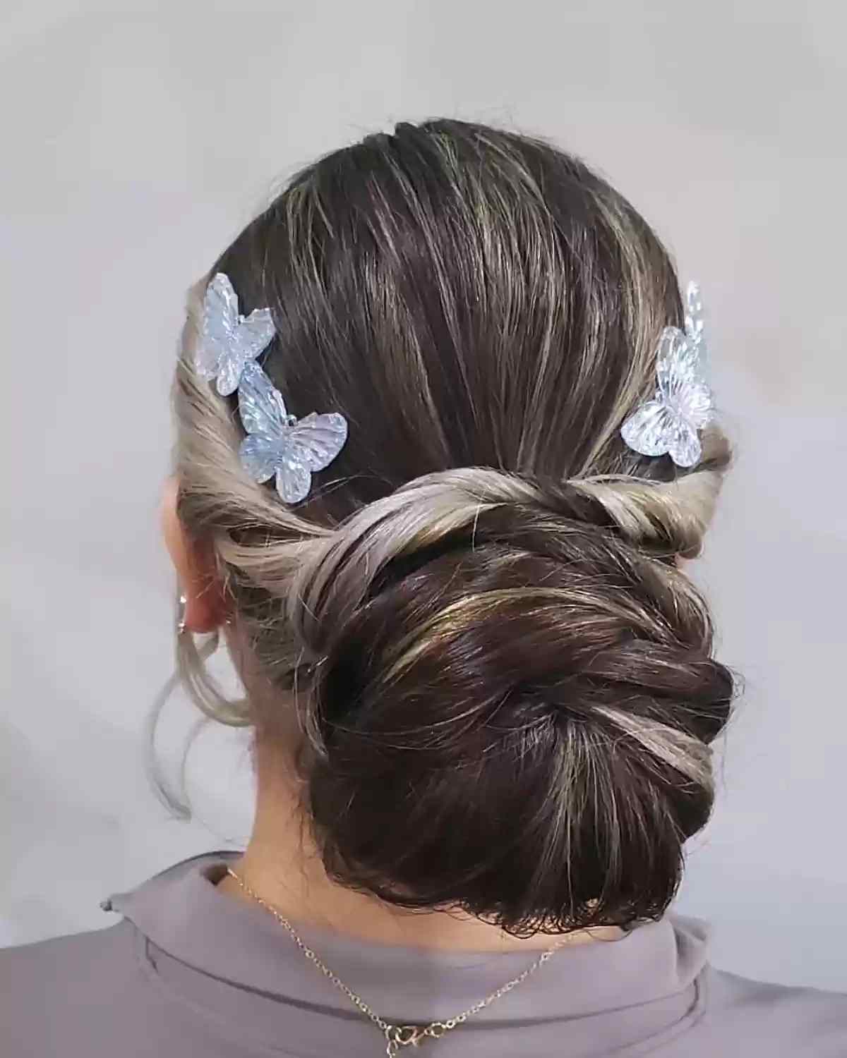 Elegant Low Jumbo Updo Bun Decorated with Butterfly Clips for Longer Locks