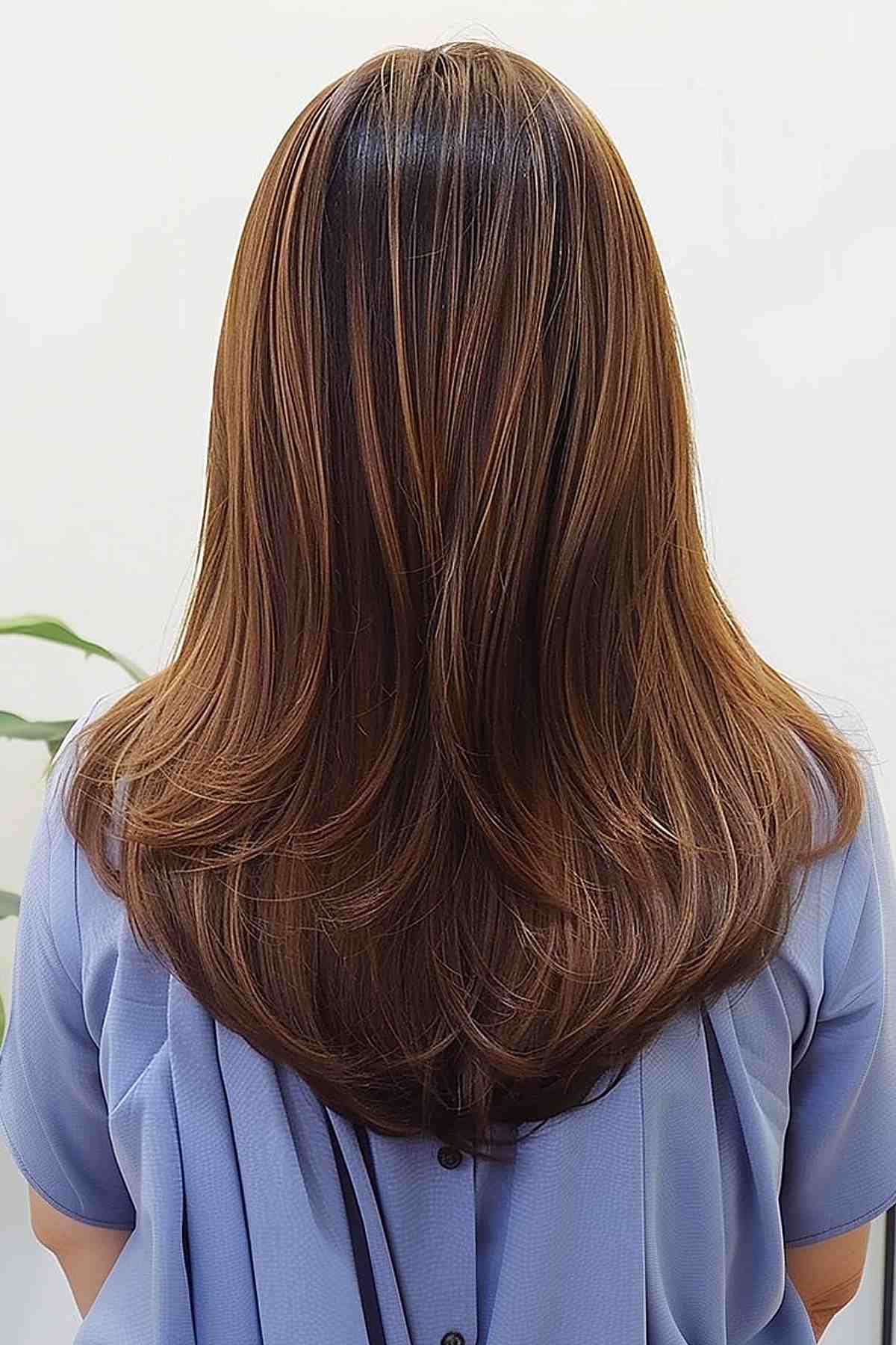 Stylish medium cut designed with V-cut layers for straight hair.