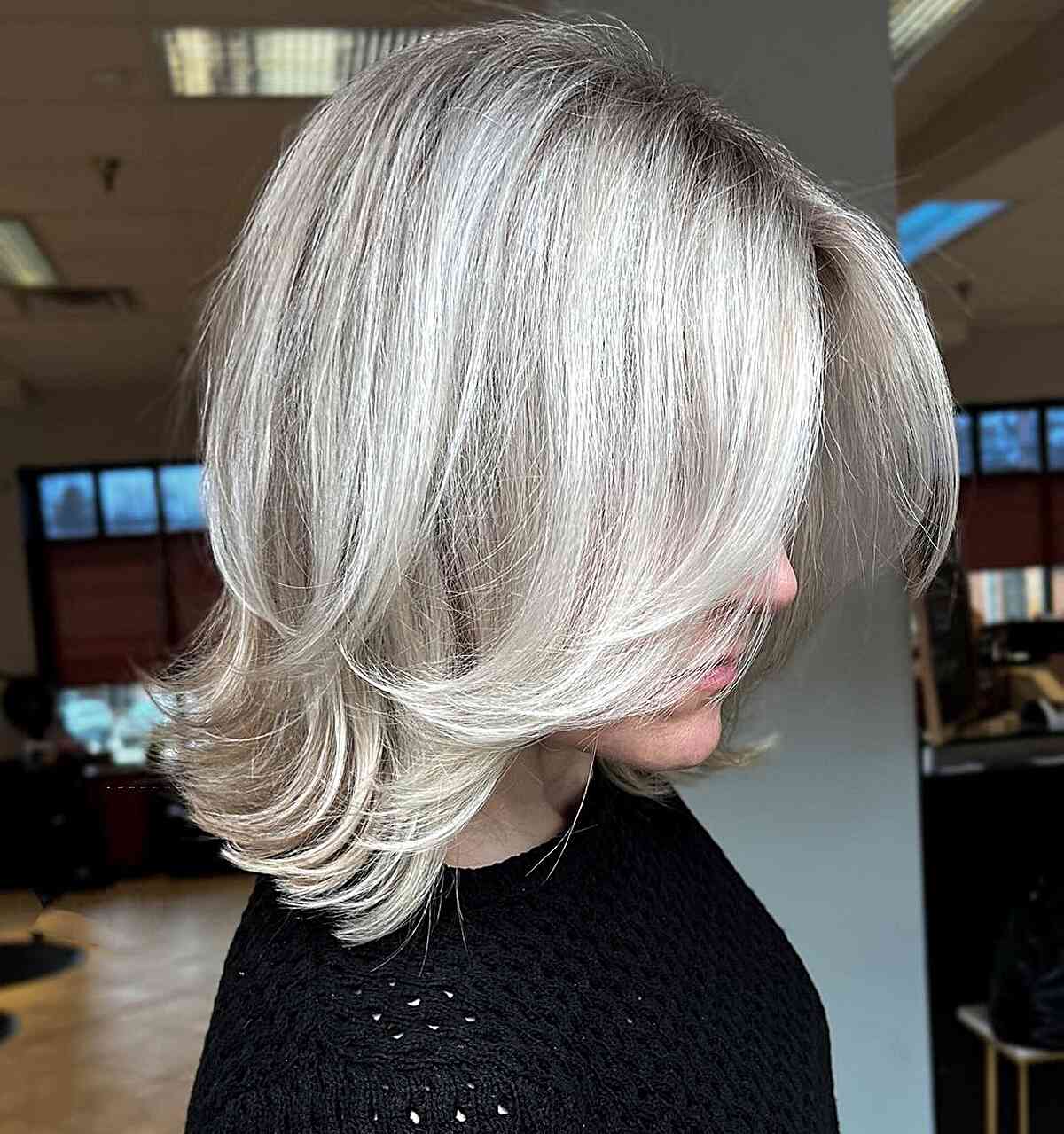Elegant Platinum Feathered Layers on a Mid-Length Cut for Fine Hair
