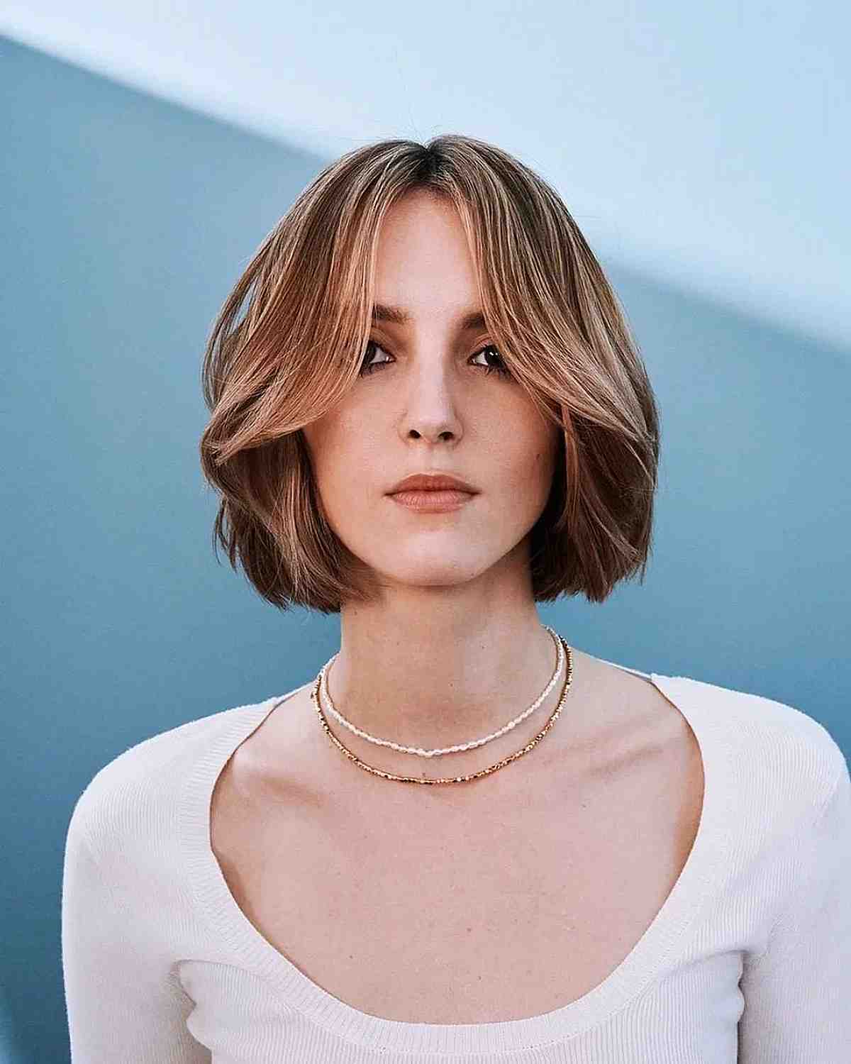 Elegant Shaggy Bob with Long Curtain Fringe and a Framing Layer for Straight Hair