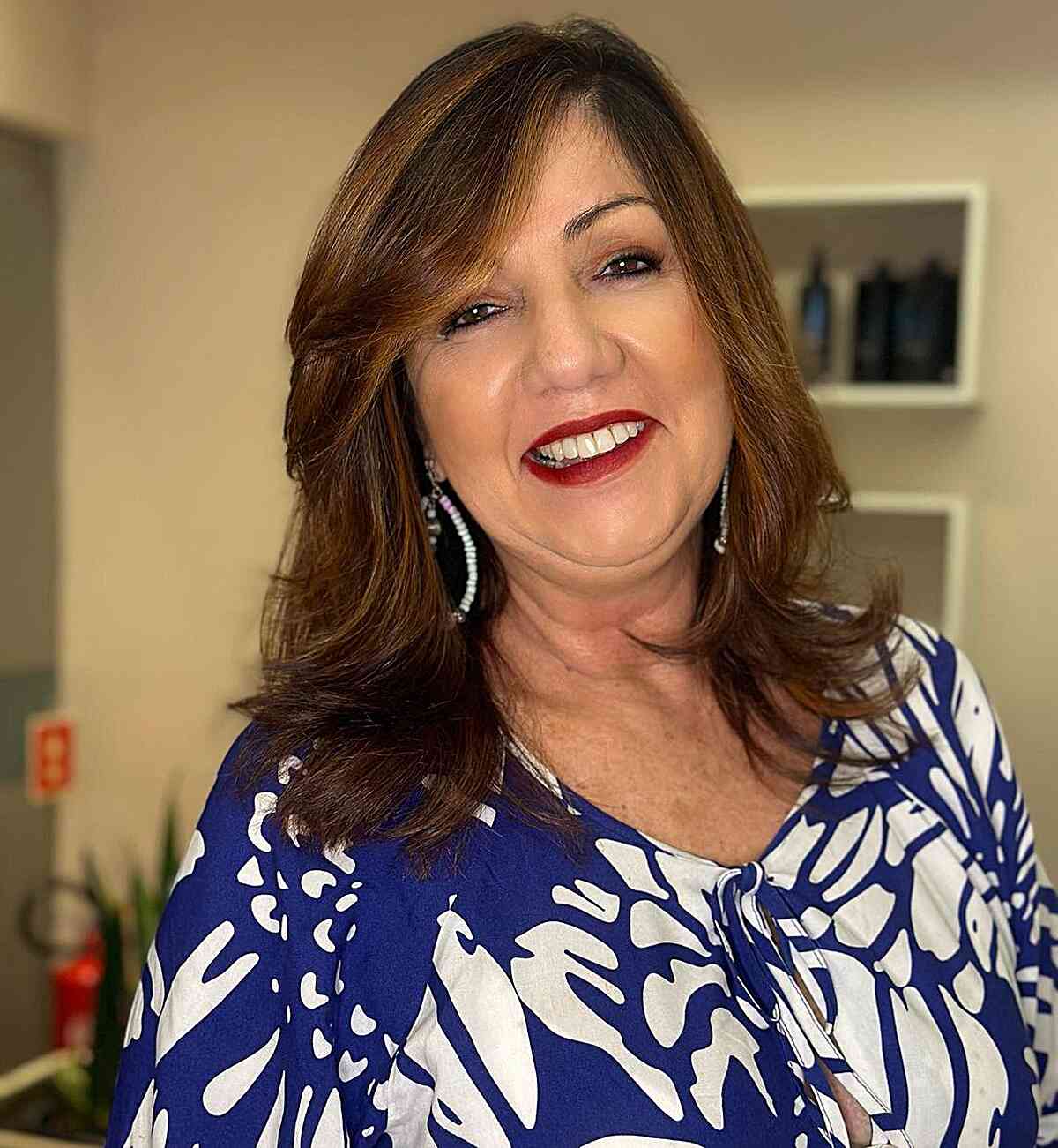 Elegant Side-Swept Mid-Length Hairstyle for Ladies Over Fifty with dark brown hair