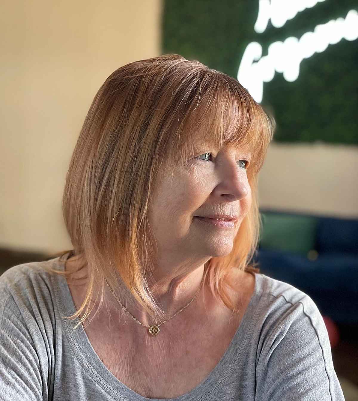 Elegant Straight Shaggy Bob with Light Bangs for a 60 Year Old Woman