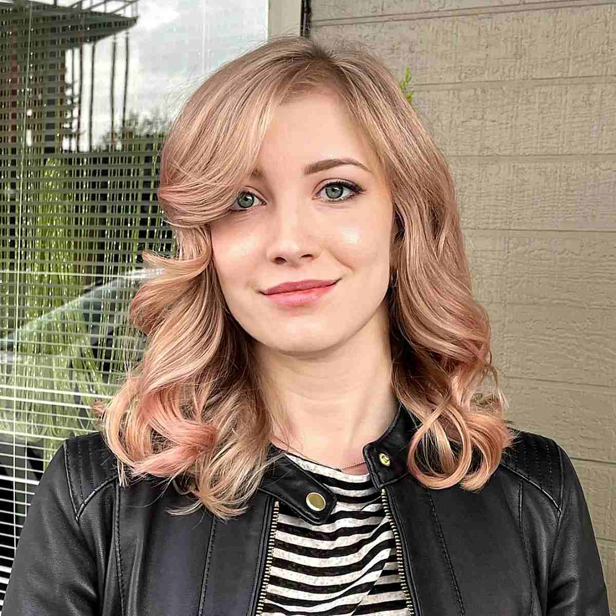 Medium-Length Wavy Hair Featuring Elegant Sweeping Bangs