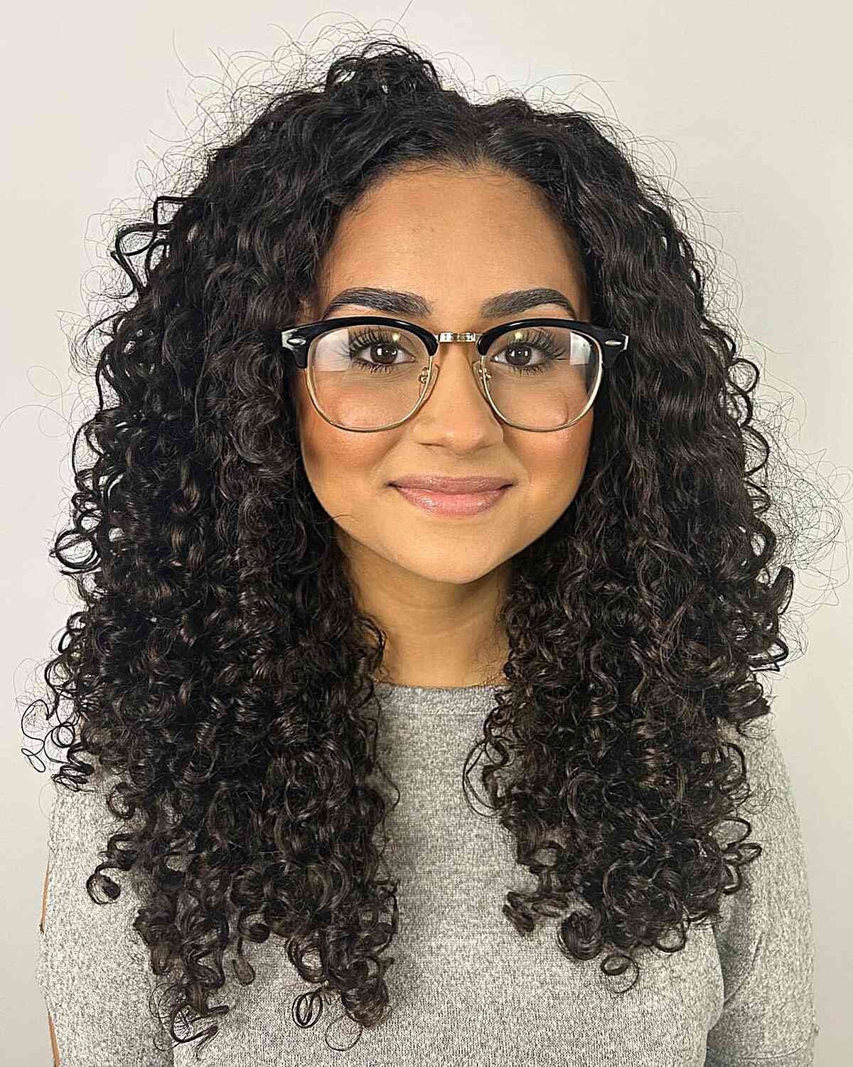 Elegantly Styled Long Curly Hair for women with eyeglasses and prominent cheeks