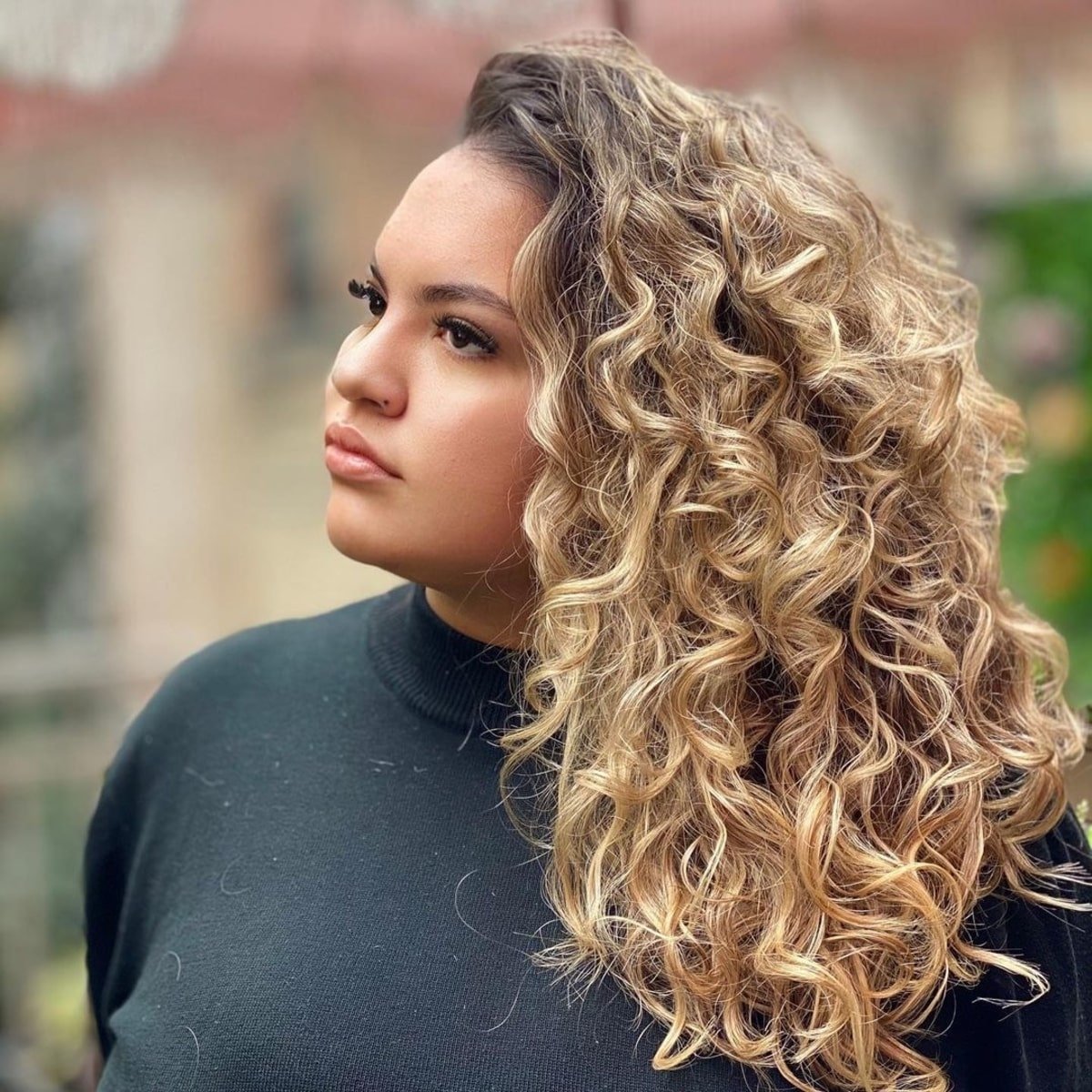 Extended-length hairstyle featuring vibrant blonde curls