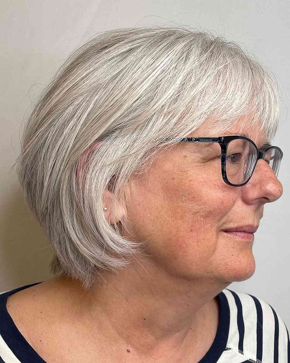 Feathered Bob with Bangs for Women Over 60 Wearing Glasses