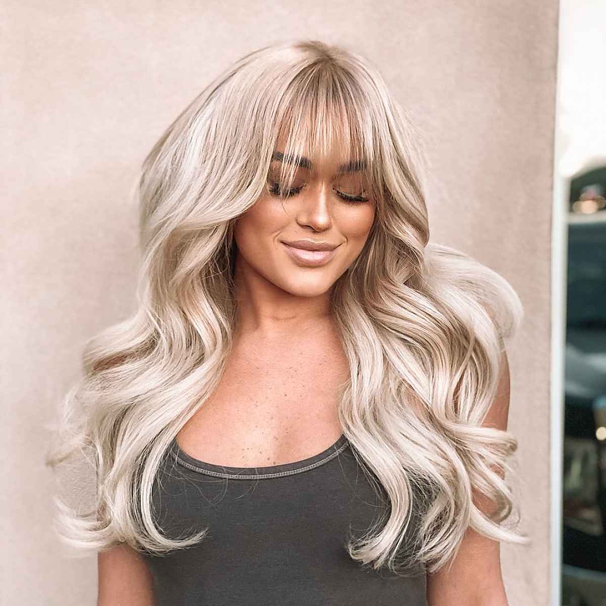 Feathery Bangs and Ample Voluminous Waves on Long Hair