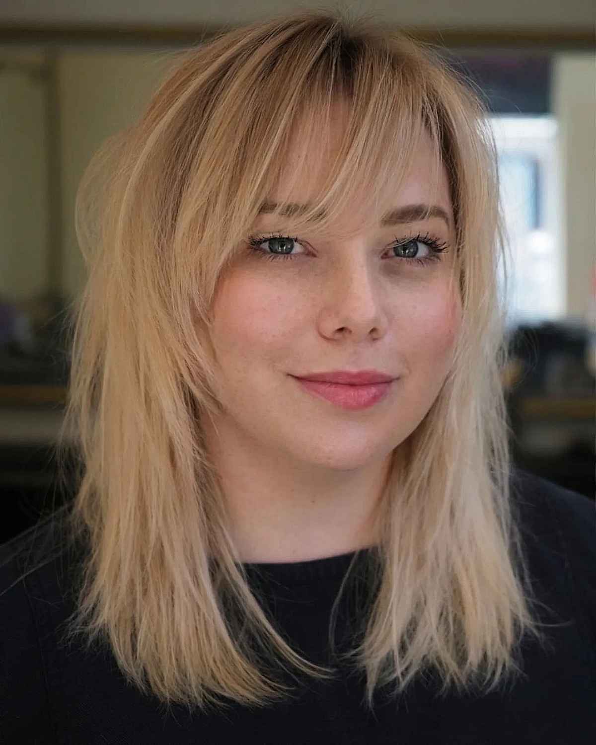 Feathery Bangs on a Blonde Mid-Length Shag