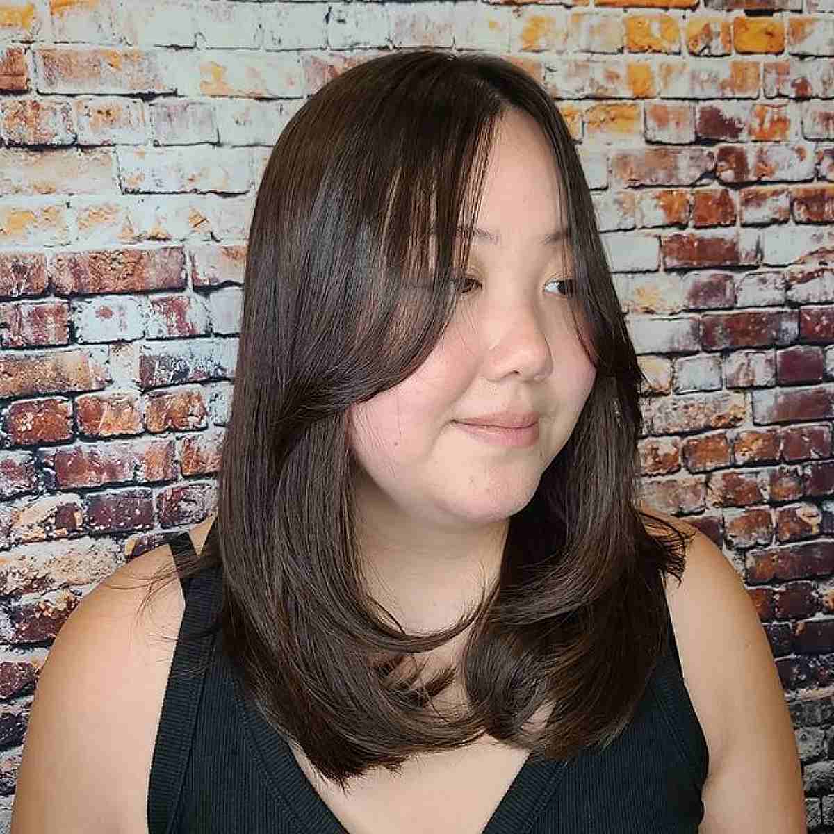 Flattering Face-Framing Layers and Long Curtain Bangs for Straight Thinner Hair