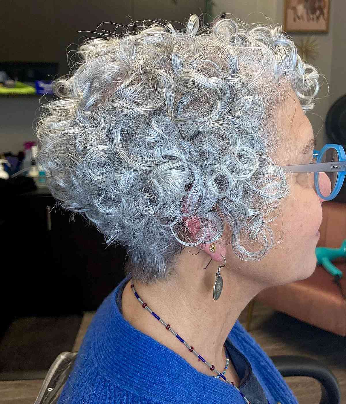 Flowing Curly Pixie Hairstyle for Ladies in Their Sixties