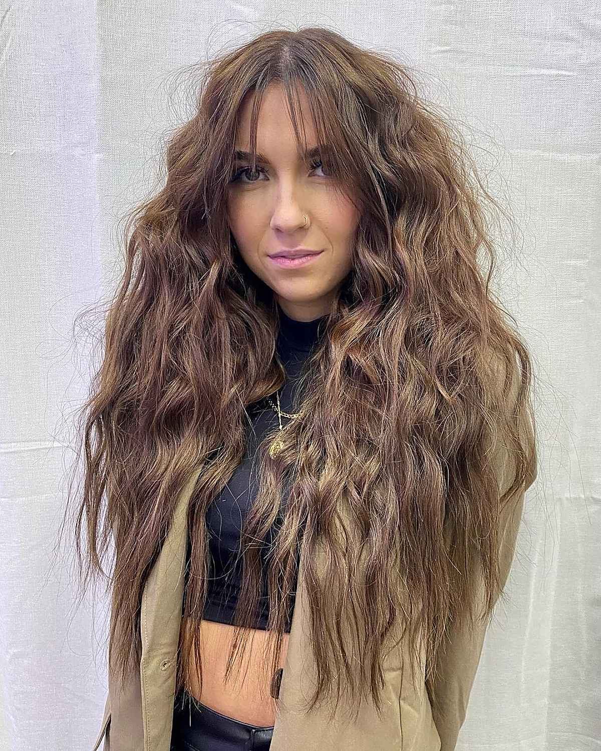 Flowing Textured Hair with Center-Parted Wispy Bangs