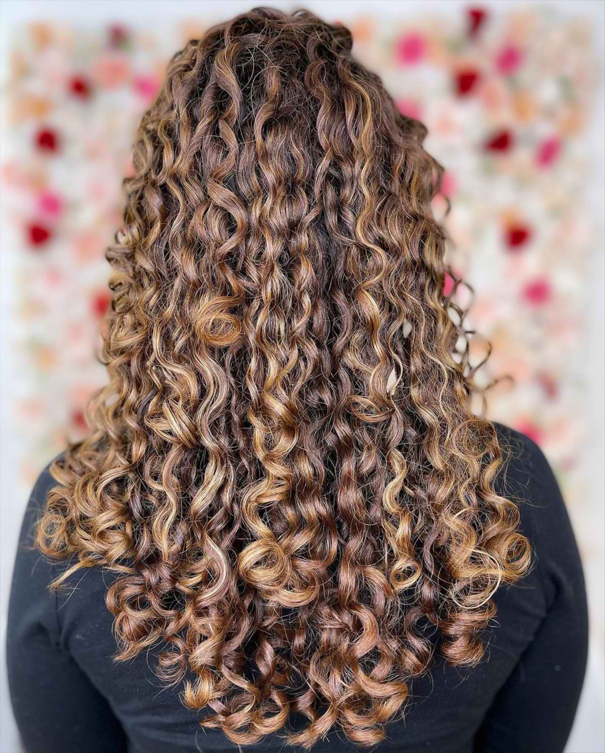 Gorgeous spiral curls for long hair enhanced with honey blonde balayage