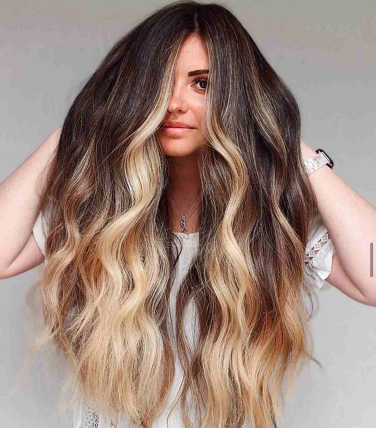 Illuminate Your Look with Light Strawberry Blonde Balayage on Long Dark Brown Hair