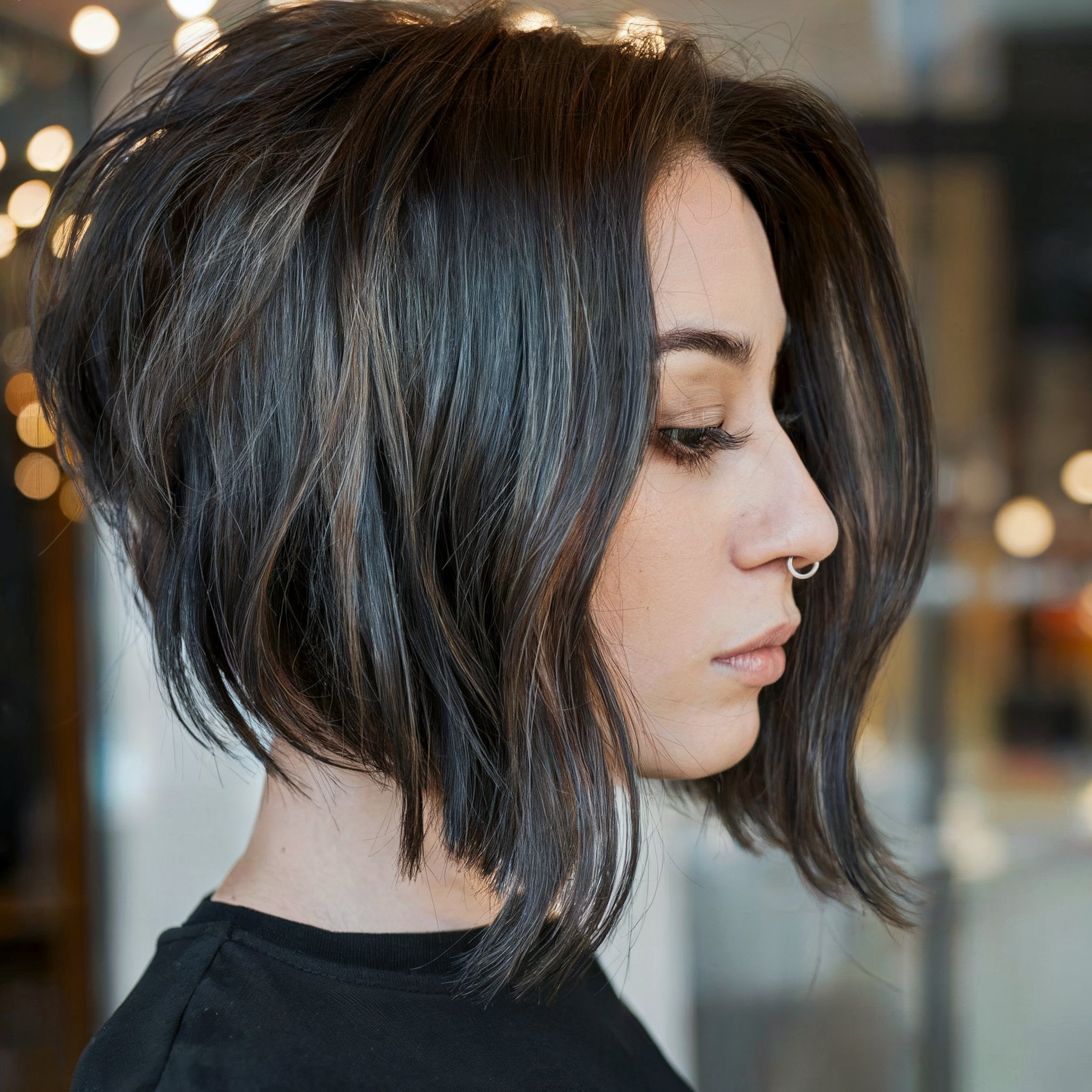 Layered angled bob featuring subtle ashy highlights and textured ends