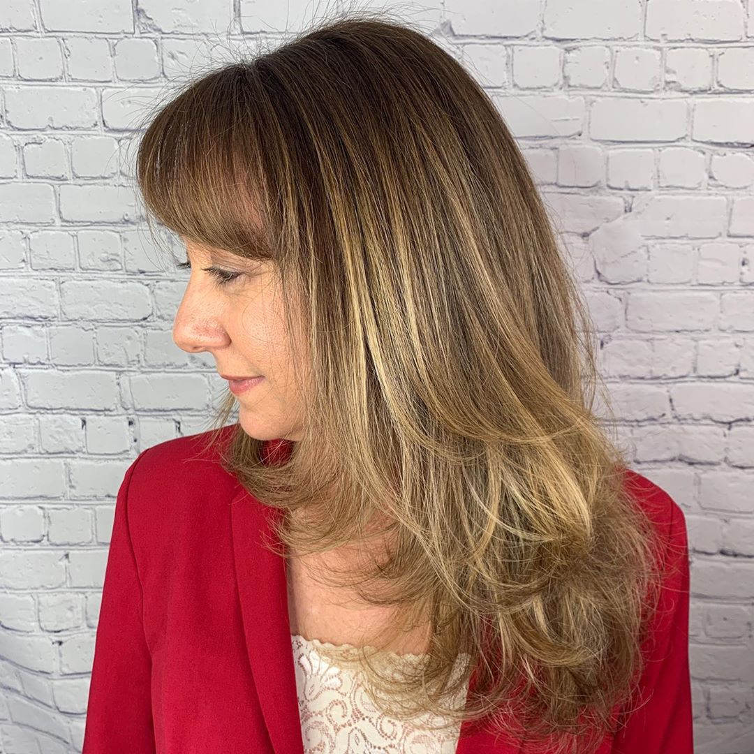 medium length layered hairstyle for women over 50