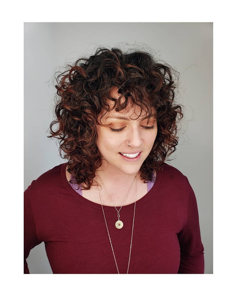 Layered Brunette Curly Bob with Bangs