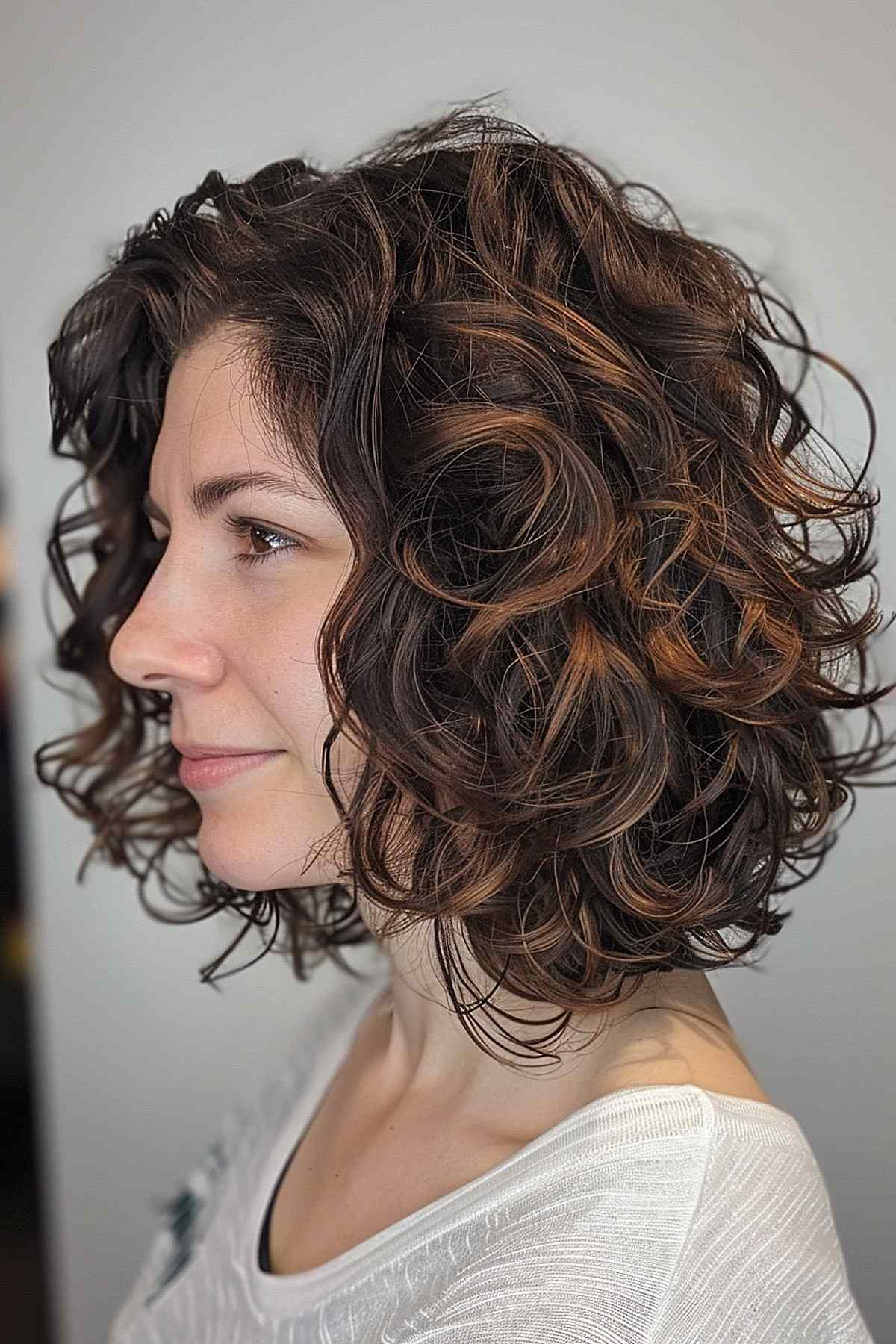 Short layered curly bob with fringe for thick, naturally curly hair