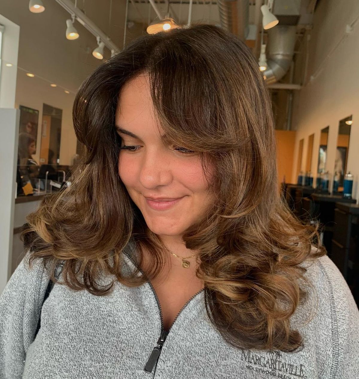 Layered Hair with Curtain Bangs and Curly Tips