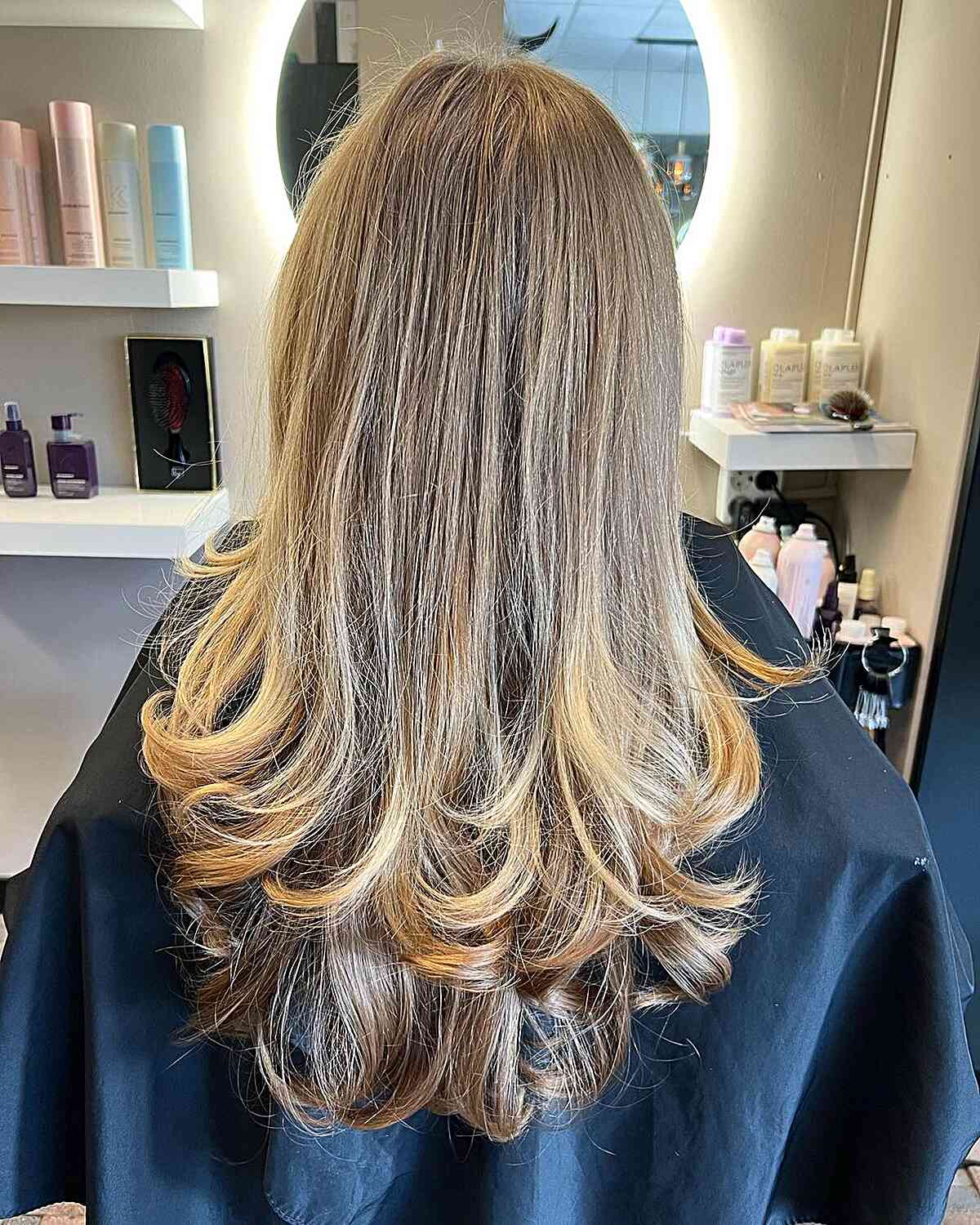 Long Layered Butterfly Haircut Featuring Blonde-Brown Shades