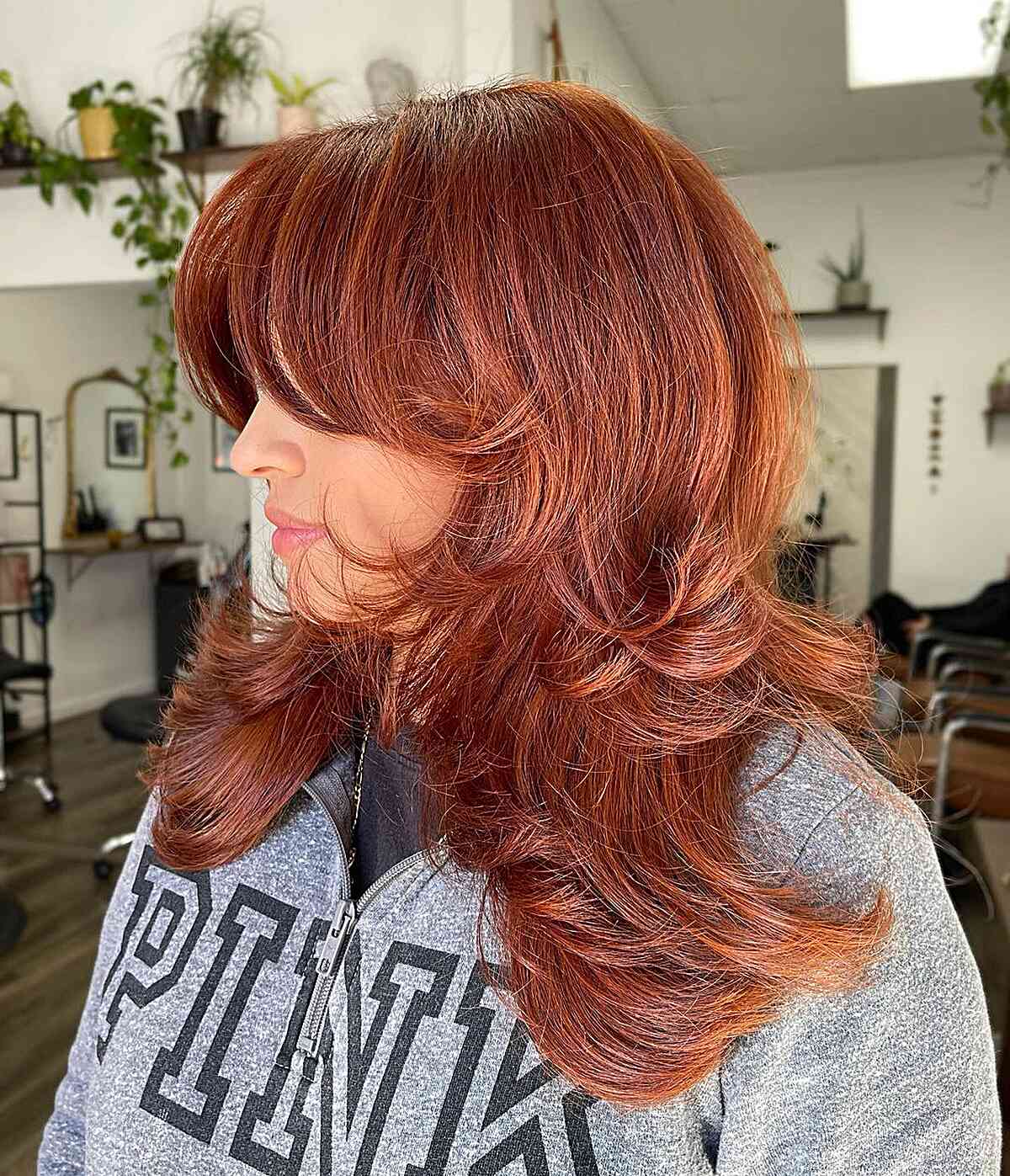 Layered Medium Feathered Hairstyle with Cheekbone-Length Bangs