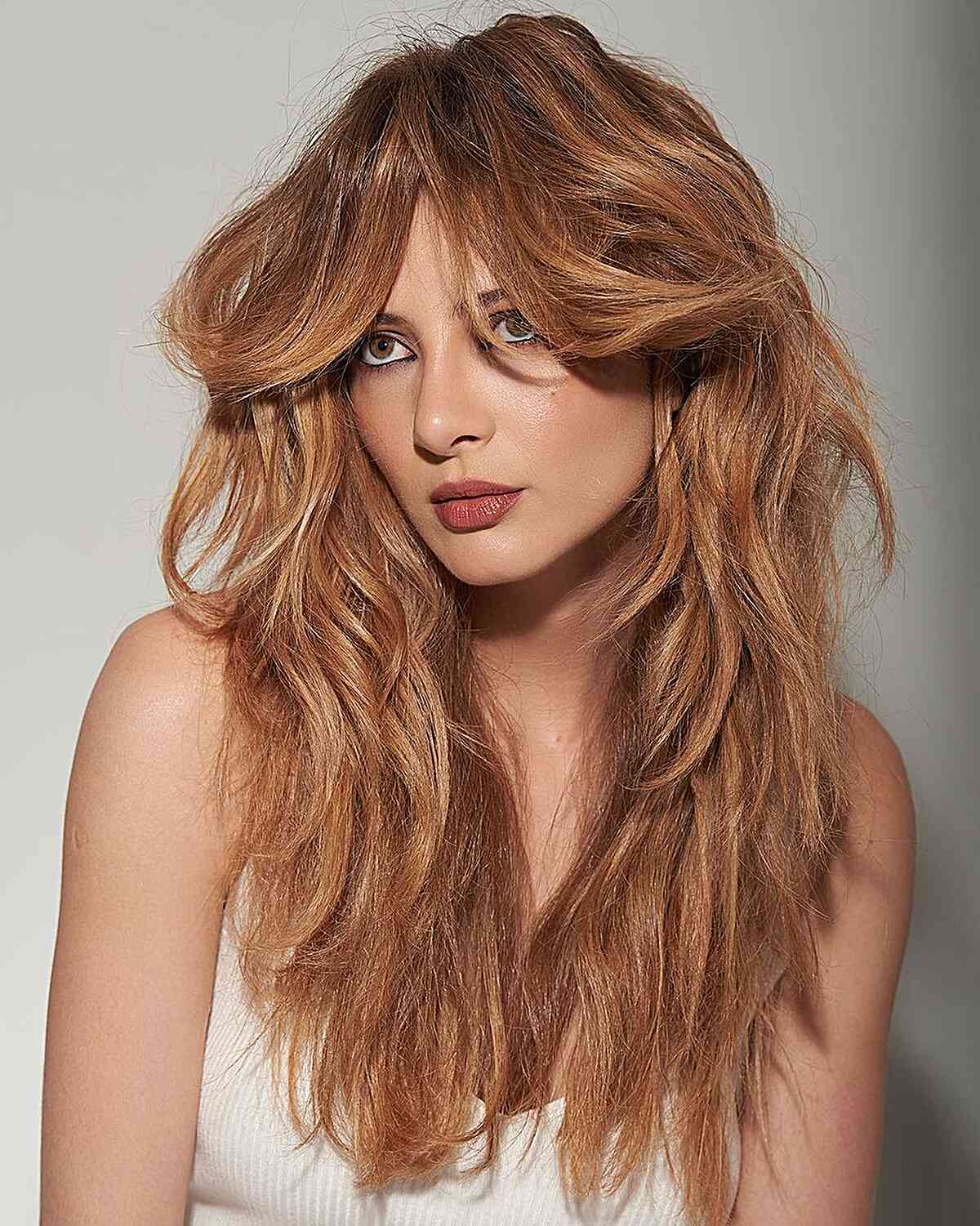Layered, Voluminous Shaggy Haircut with Bangs for women with long, layered hair