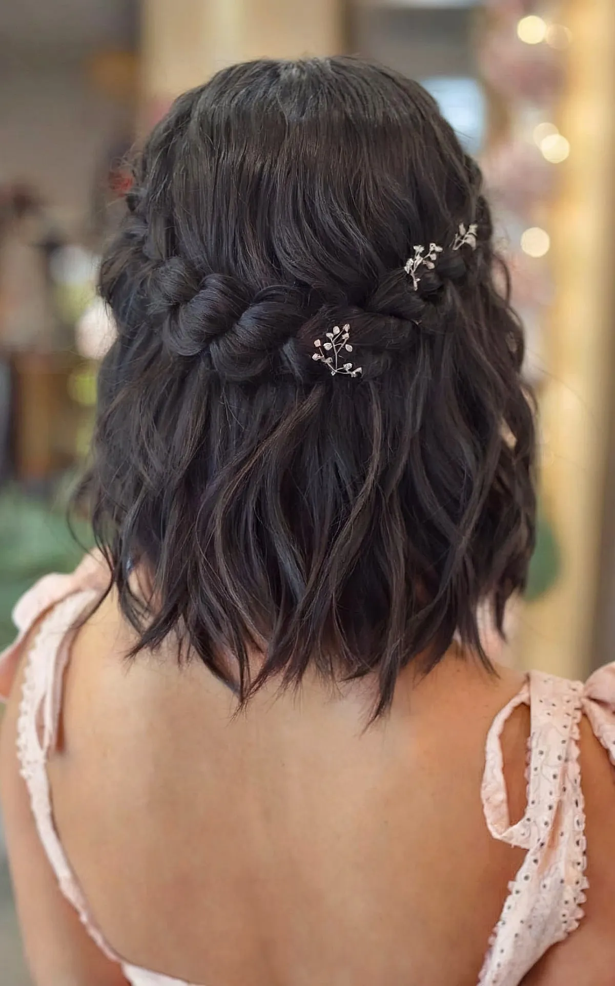 Long Bob Featuring a Half Wrapped Braid and Delicate Floral Accents