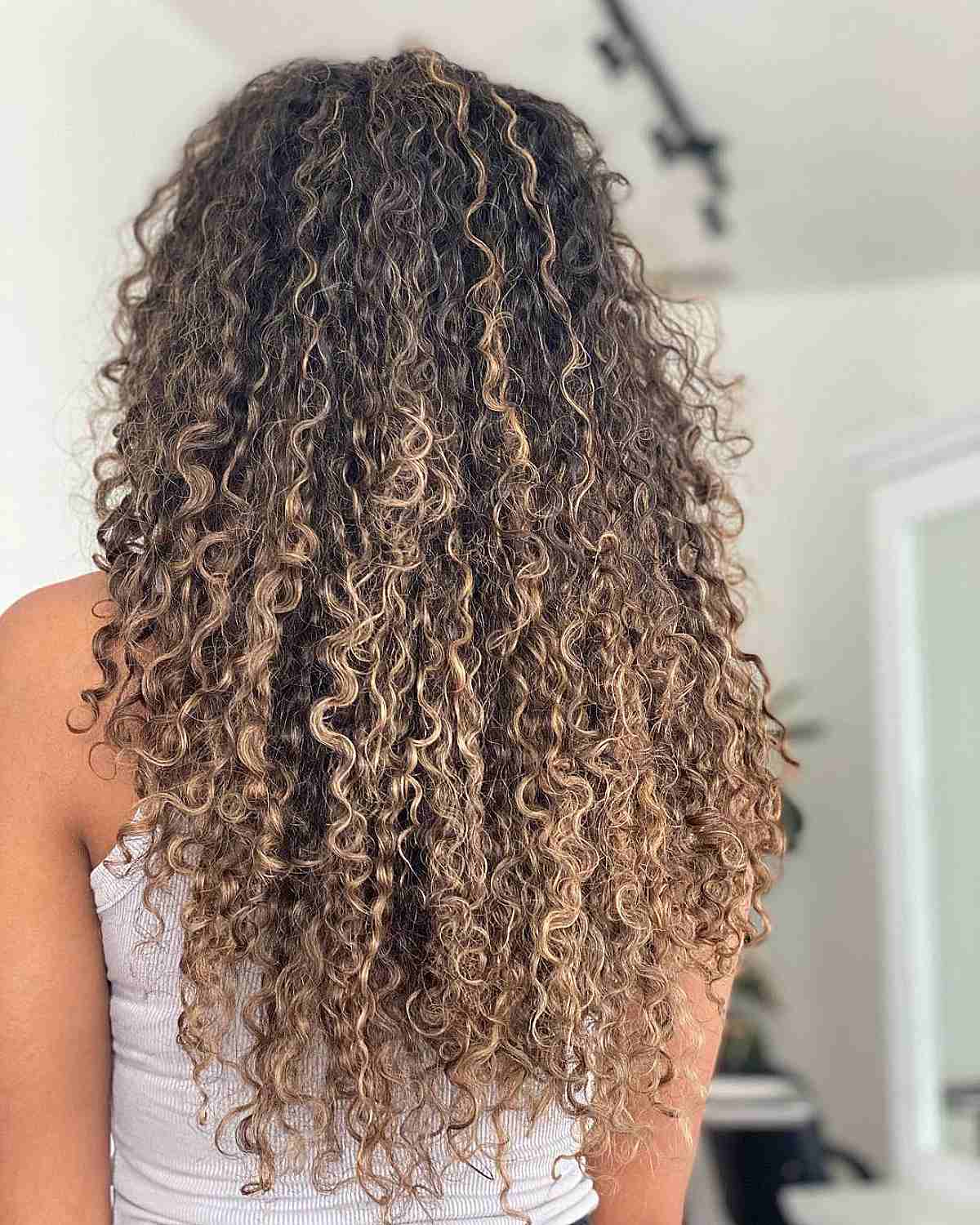 Long Curly Hair with Balayage Blonde Highlights