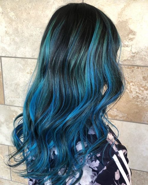 Striking pastel blue highlights on black hair