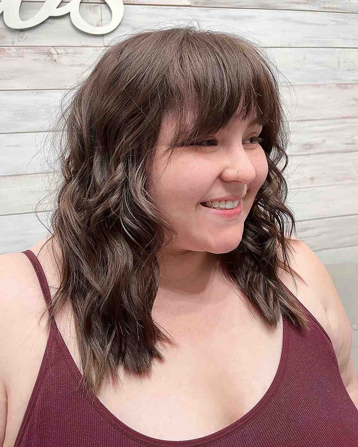 long wavy layers with textured fringe for round faces