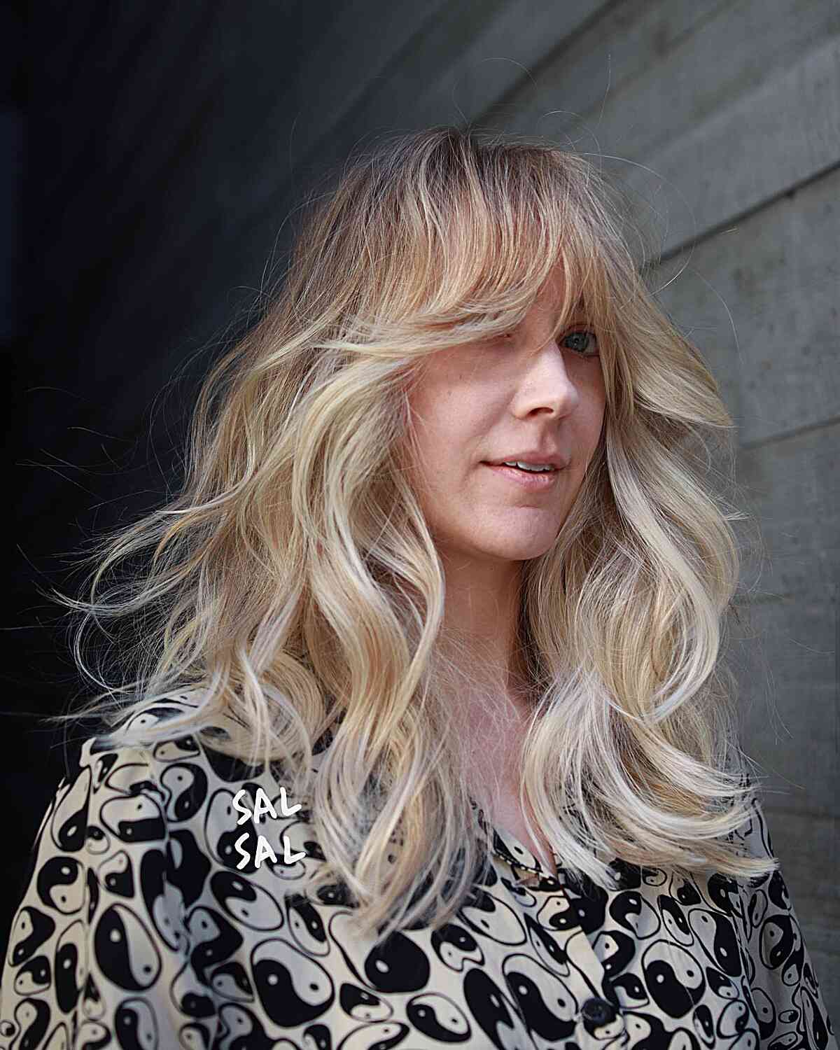 Medium-Length Luxurious Blowout Waves with Curtain Bangs and Blonde Balayage