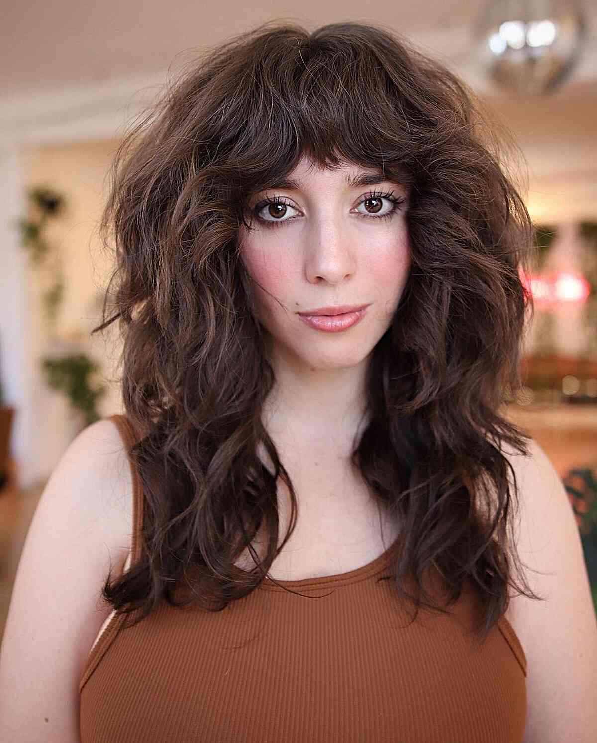 Luxurious Thick Shag Featuring Bangs on Medium-Length hair and choppy ends