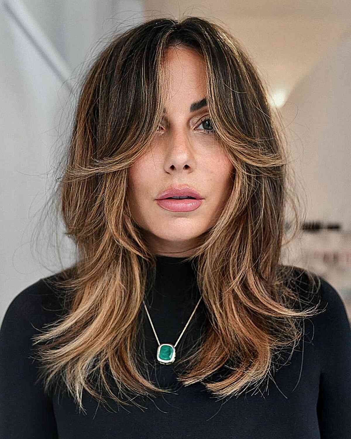 Medium Layers with Face-Framing Feathered Bangs