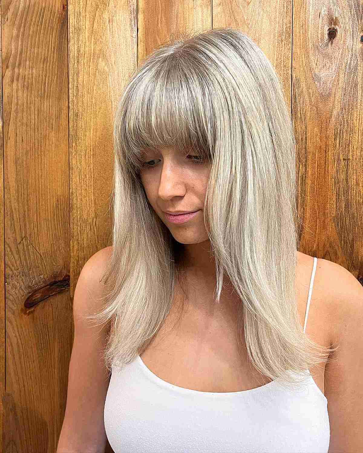 Medium-Length Straight Hair Featuring Long Layers and Bangs