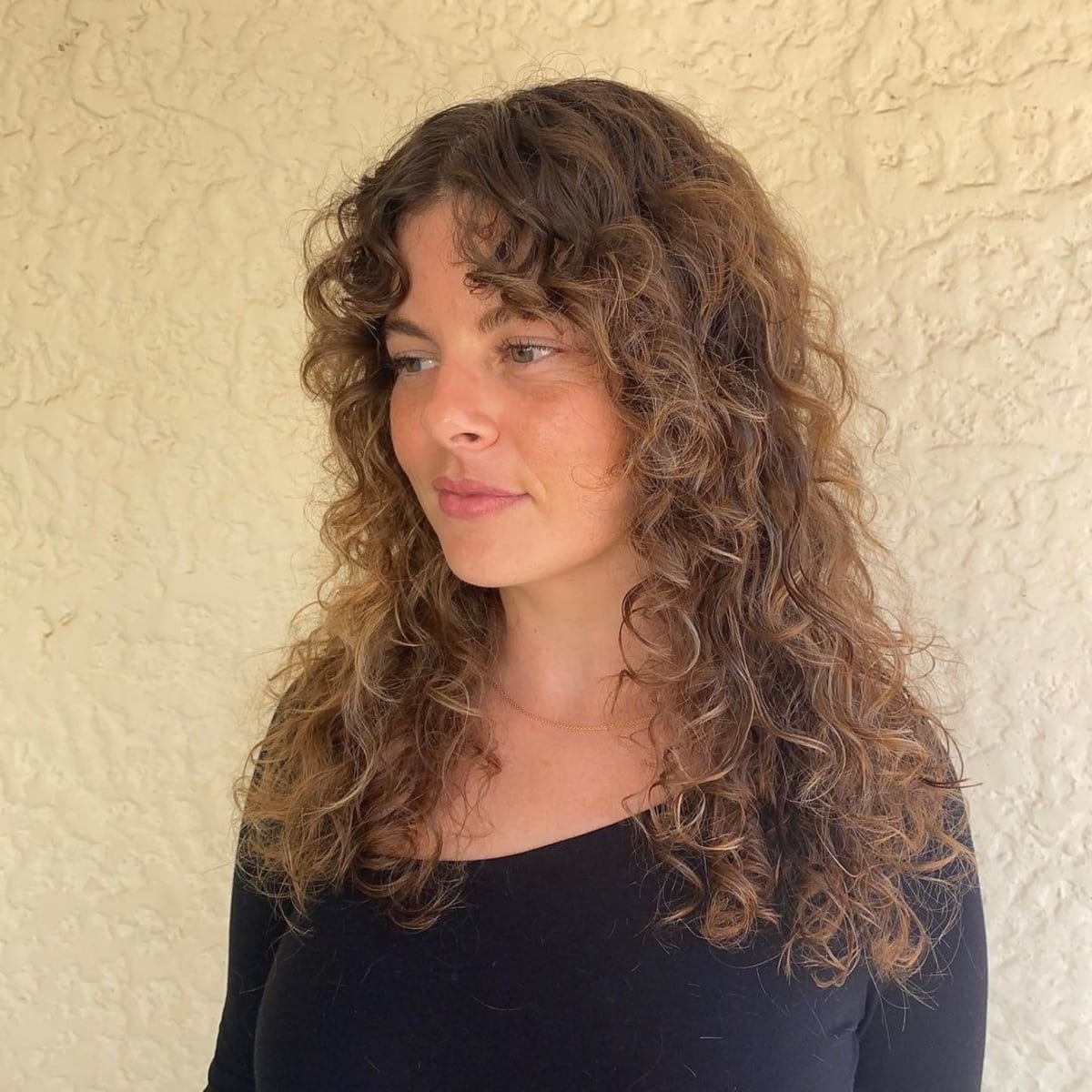 Medium-length hair with curly curtain bangs