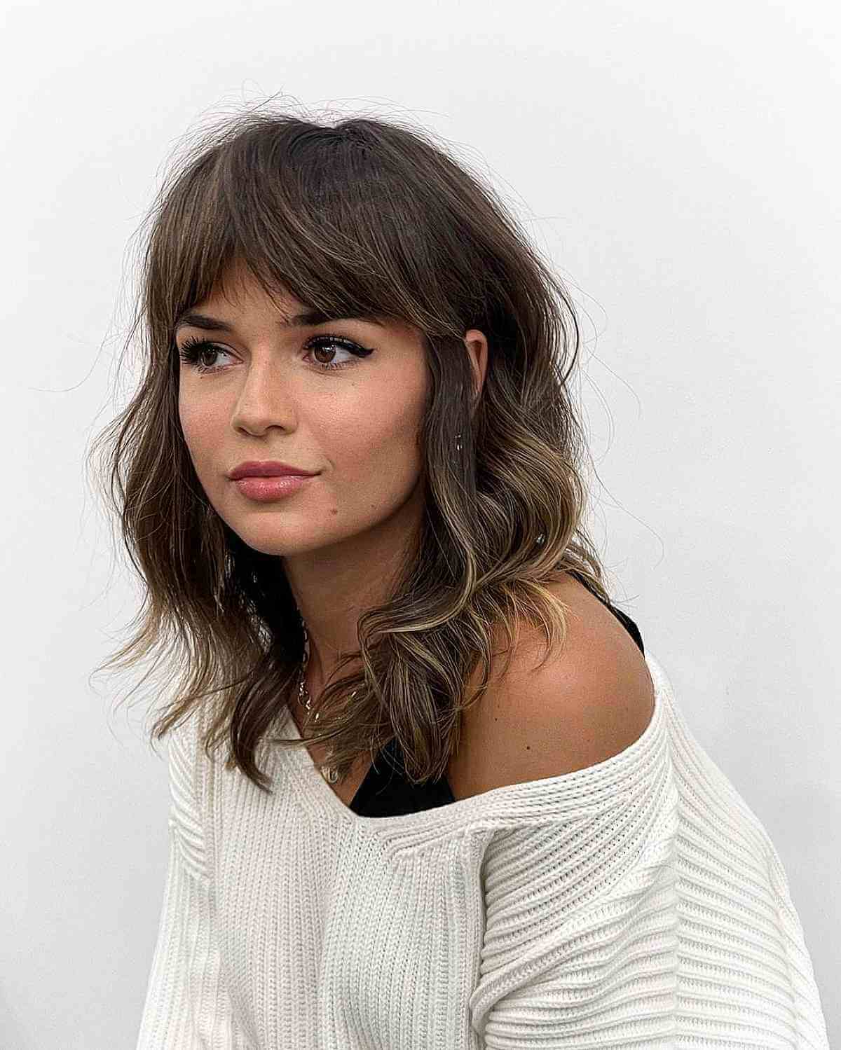 Medium-Length Hair with Eyebrow-Grazing Bangs