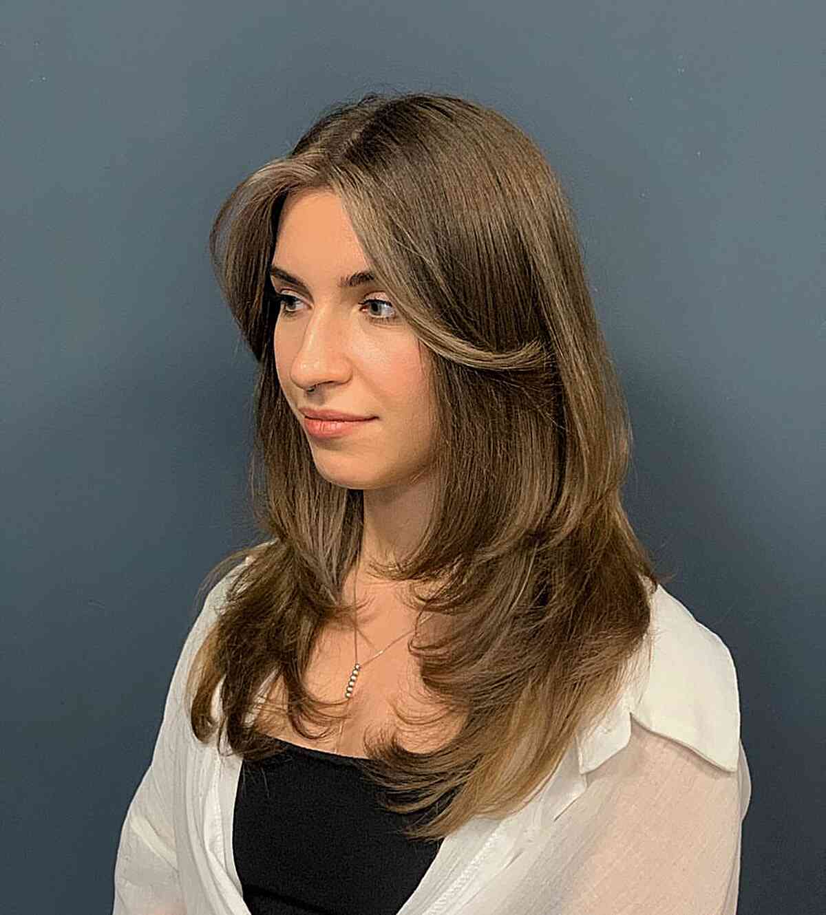 Medium-Length Feathered Layers with Extended Fringe on Brunette Women