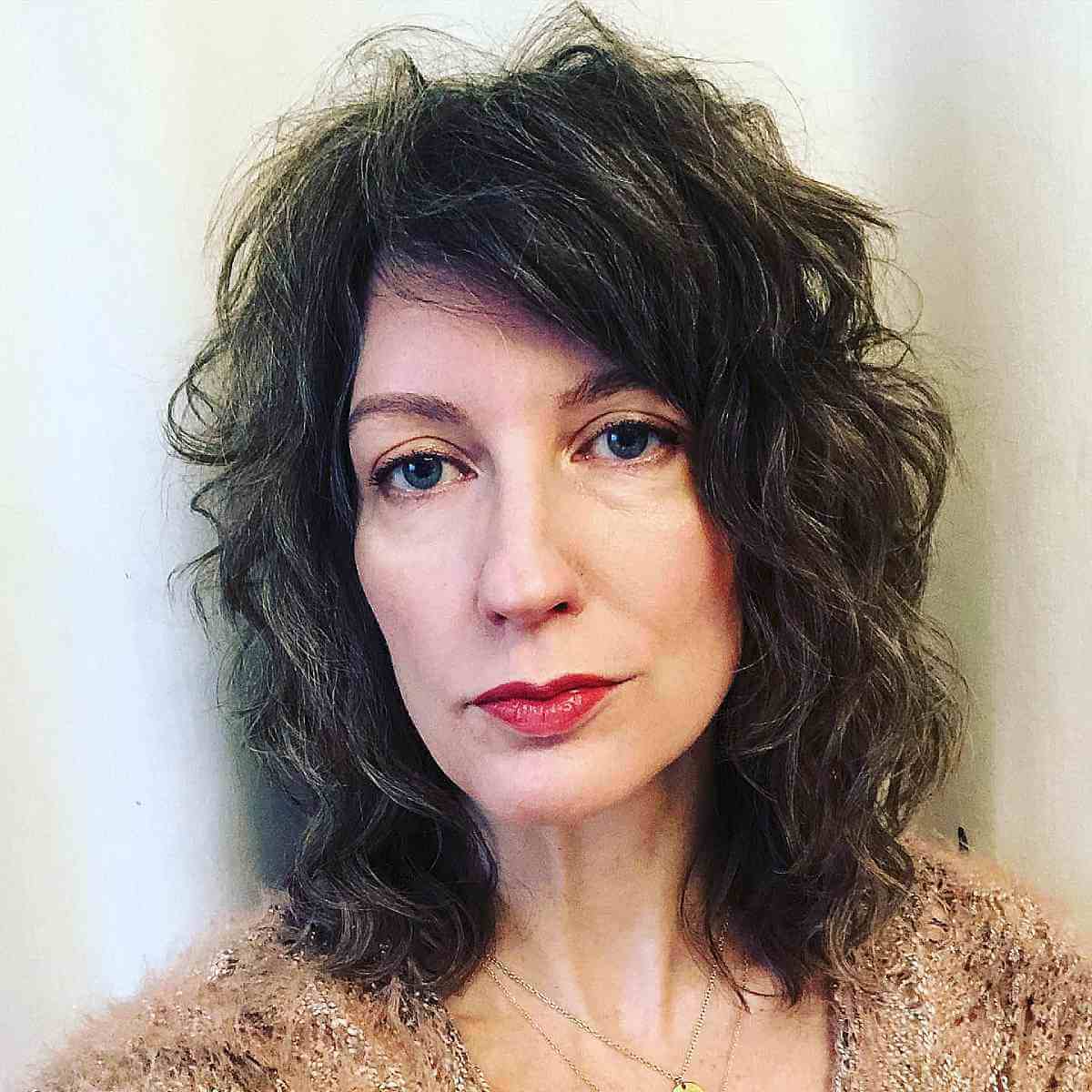 Medium-Length Wavy Shag with Side Bangs for Women Over Forty