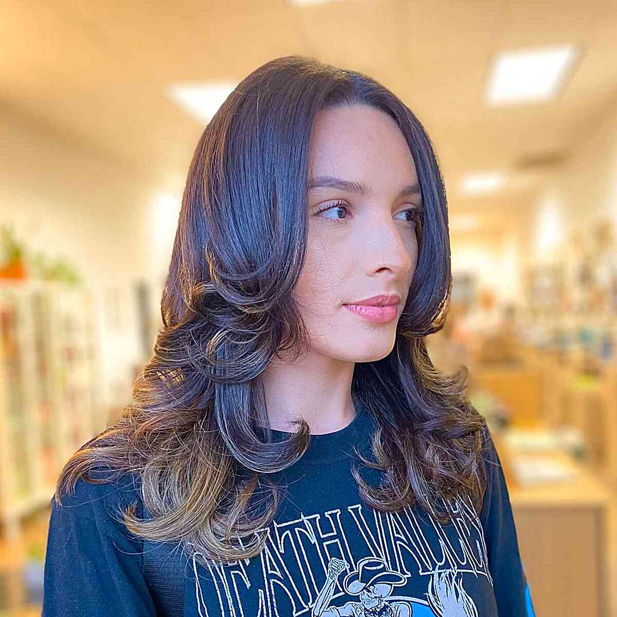 Medium Multi-Layered Hairstyle with Softly Curled Ends for Dark-Haired Women